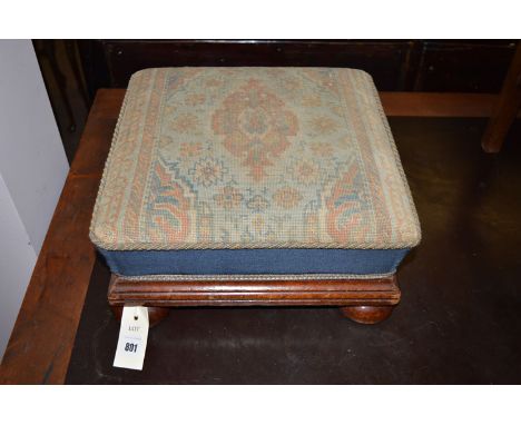 A 19th Century square-shaped stool, the top with hand-worked tapestry cover, on square-shaped mahogany frame with turned feet
