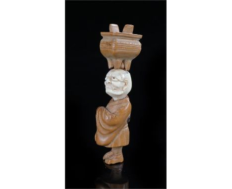 Japanese Meiji ivory and boxwood netsuke, the figure with an ivory head and boxwood body, together with a vessel, the figure 