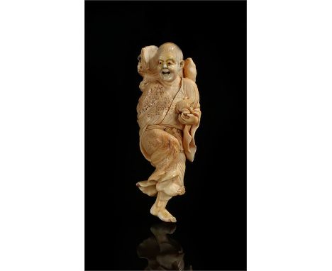 Fine and of large proportions Edo period ivory Netsuke of Gama-Senmin smiling as he stands on one foot, supporting a a huge t