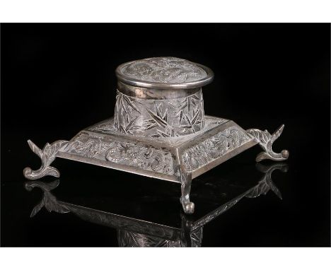 Chinese silver inkwell, the hinged lid with a dragon above a body with leaf and further dragon design raised on arched legs, 