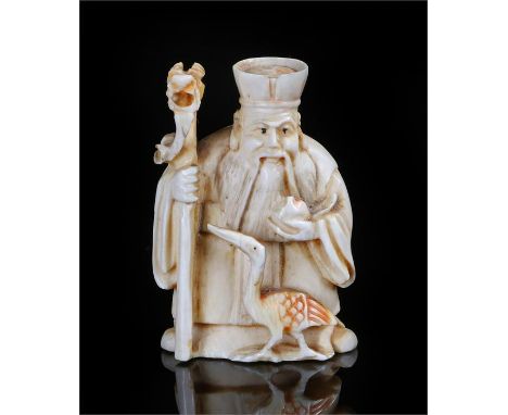 Meiji period ivory Netsuke of Jurojin, carved as an old man with a staff and a crane at his feet,  he is generally depicted i