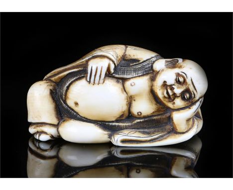 Japanese Meiji period ivory netsuke, carved as a reclining daruma, signed, 5cm long