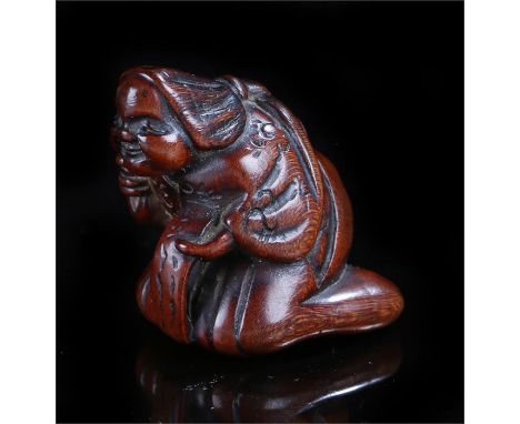 Japanese Edo period netsuke, carved as Okame crouching, 3.5cm high 