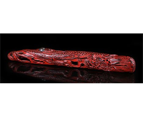 Meiji Senryuzutsu type pipe case of Negoro-style lacquer formed as a dragon chasing a pearl. length 24.5cm