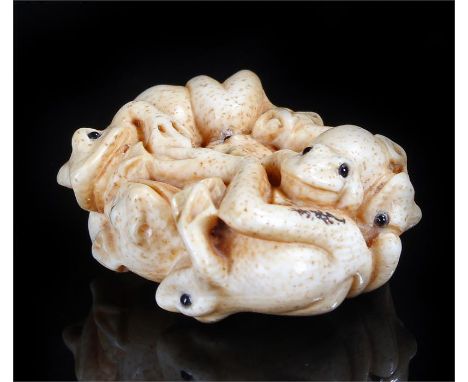 Meiji period Japanese ivory Netsuke carved as interlinked frogs with inlaid eyes, signed