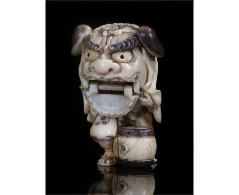 Fine Japanese ivory Meiji period netsuke, carved with a figure inside a mask costume with a movable jaw, mother of pearl inla