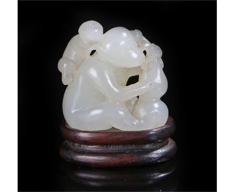 19th Century Jade carved as a monkey with a smaller monkey on it's back and holding a gourd, with hardwood stand. Height 35mm