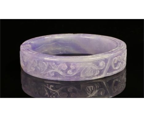 Lavender jade bangle, carved with fish and foliate scrolls, 8cm wide