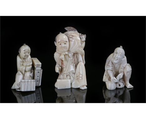 Three early 20th Century Japanese ivory okimono's, the first a man with a fox in a bag, 7cm high, the second as a man killing