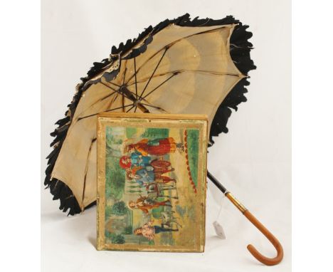 An early 20th Century child's black silk and cream fabric parasol, together with a boxed Edwardian block puzzle of children p