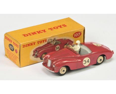 Dinky Toys 107 Sunbeam Alpine Sports car - Cerise Body, grey interior with figure driver, silver trim, light beige rigid hubs