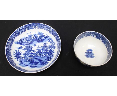 A Davis and Flight period Worcester tea bowl and saucer decorated in underglaze blue with the 'figure on a bridge' pattern, c