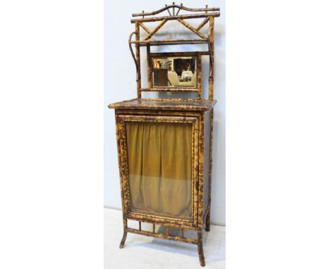 A late 19th century bamboo side cabinet, raised back with shelf and mirror above a single glazed door, 61cm wide