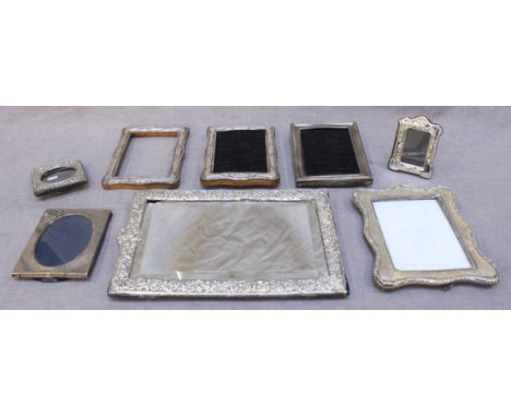 A silver-mounted easel mirror together with seven various silver-mounted easel photograph frames, (AF)