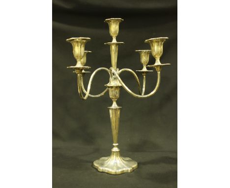 A George V silver five-light candelabra, with detachable cartouche-shaped drip pans and spreading base, Sheffield, 1910, Walk