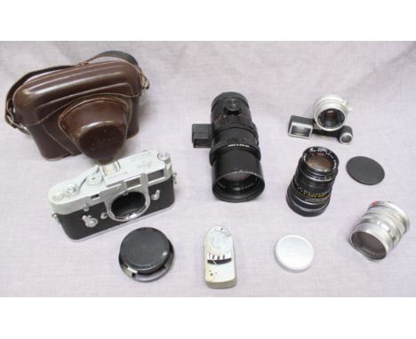 A Leica M3 single wind camera, by Ernst Leitz Wetzlar Germany, together with four lenses consisting; a 1:2.8/90mm Tele-Elmari