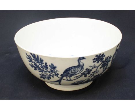 An 18th century Worcester porcelain slop bowl decorated in under-glaze blue with the 'Bird in a Tree,' pattern, crescent mark