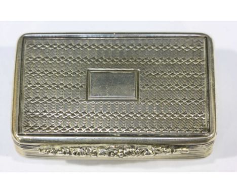 A William IV silver and silver-gilt snuff box of rectangular form with hinged cover, engine-turned top and base, reeded sides