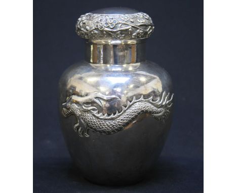 A Chinese Export silver tea caddy  / canister, of ovoid form embossed to the body with two dragons, the slip-on mushroom cove