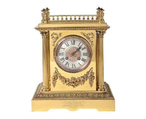 A French brass mantel clock, late 19th c, of pillar shape flanked by columns beneath stepped pediment with gallery, gong stri