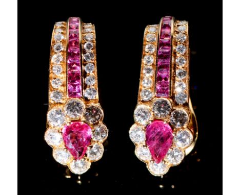 A pair of ruby and diamond ear clips, with heart shaped cluster and line and calibre cut rubies, in gold, 24mm, signed 'Graff