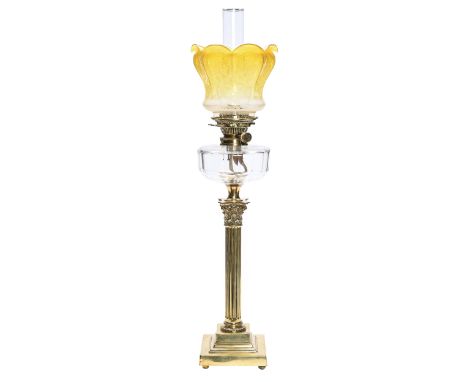 An Edwardian brass Corinthian column oil lamp, with faceted glass shade, brass burner and an etched and amber shaded glass sh