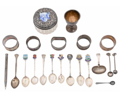 Five silver napkin rings and an eggcup, various makers and dates, miscellaneous silver souvenir spoons and other articles, in