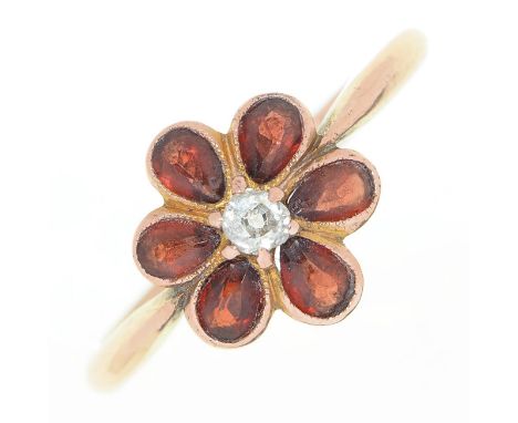 A diamond and garnet flower cluster ring, in gold marked 9ct, 2.8g, size Q Diamond of irregular shape and slightly chipped, l