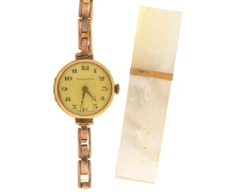 A Tavannes 9ct gold lady's wristwatch, 26mm diam, import marked London 1924, on a gold coloured metal expanding bracelet and 