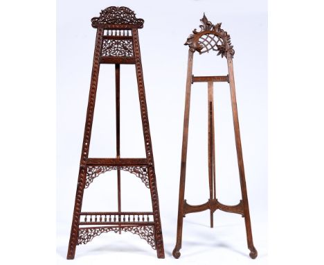 An Indian carved wood easel, late 19th / early 20th c, with cresting and panel of birds in branches, 184cm h and another ease