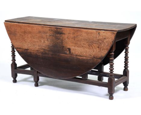 A George II oak table, with bobbin turned legs, 74cm h; 148 x 160cm Structurally unstable, much dirt, uneven fading and stain