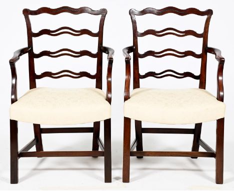 A pair of mahogany ladder back elbow chairs, c1930,&nbsp;in George II style, with dished seat, seat height 43cm Light surface