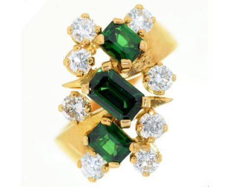 An emerald and diamond ring, with three step cut emeralds, in gold marked 18, 8.5g, size L Good condition