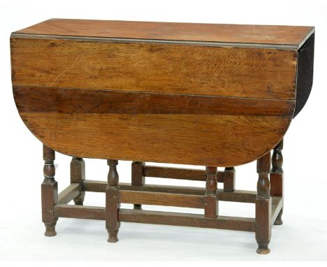 An oak gateleg table, late 19th c, 73cm h; 100 x 119cm Old blackened marks and scratches