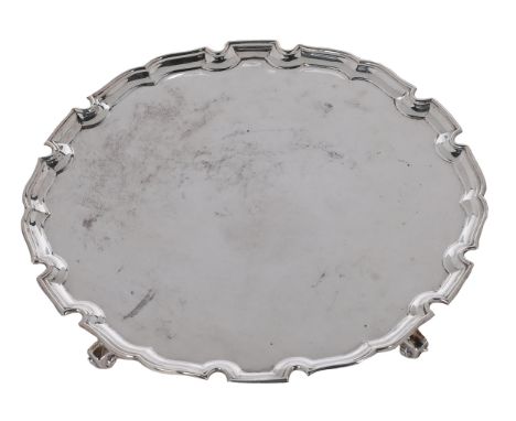 An Elizabeth II silver salver, on four volute feet, 25.5cm diam, by H H Plante, London 1955, 18ozs 5dwts Light polish scratch