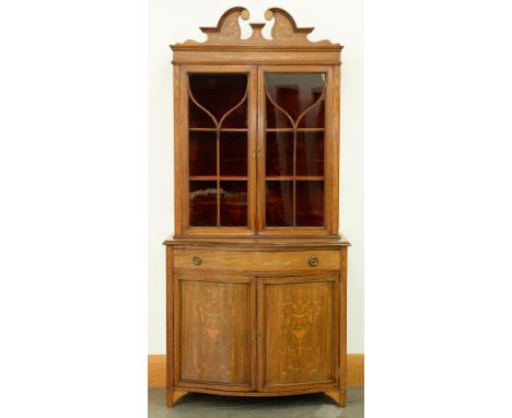 An Edwardian mahogany and inlaid china cabinet, the upper part with swan neck pediment and plush lined interior, the doors wi