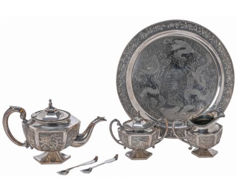 A Chinese silver tea service, c1910, the teapot, milk jug and sugar bowl, each of hexagonal shape and decorated in repousse w