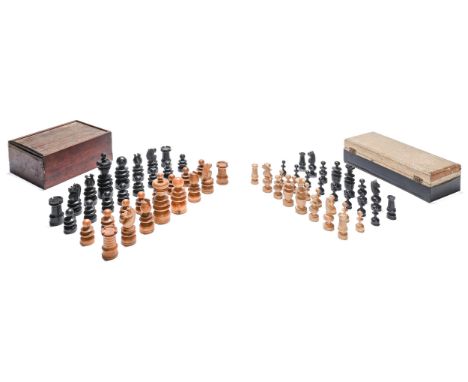 A Victorian turned wood chess set, ebonised and natural, the knights carved, kings 11cm h and another, smaller, early 20th c 