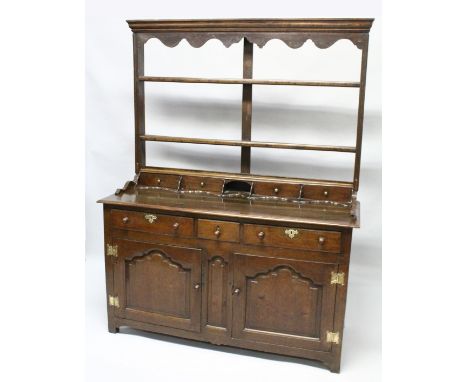 A GOOD 18TH CENTURY OAK DRESSER, the Delft rack with a moulded cornice and shaped frieze over two open shelves, the base with