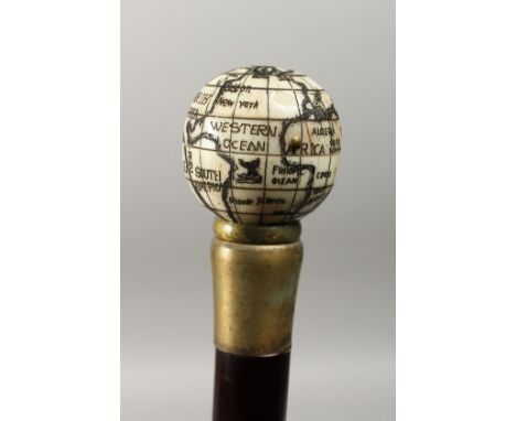 A CARVED BONE HANDLED WALKING STICK, with globe compass,. 37ins long.