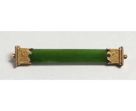 A JADE AND SILVER GILT BROOCH.