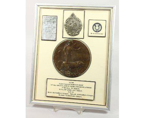 A FRAMED AND GLAZED WW1 BRONZE MEMORIAL DEATH PLAQUE or "Dead Man's Penny" S/1769. Lance Corporal Norman Shaw, 19th Bn; Argyl