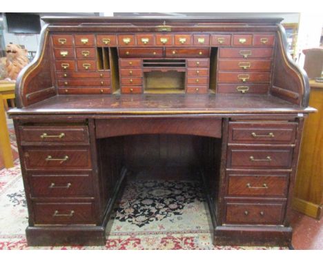 Large twin-pedestalled roll top desk with numerous drawersThis piece is approx; 151cm wide x 130cm tall x 88 deep.The roller 