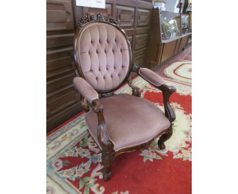 Reproduction button-backed chair with ornate oak carving