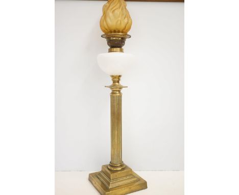 Early brass column oil lamp with milk glass reservoir & shade in the form of a flame Height 76 cm 