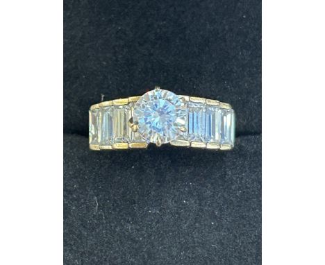 9ct Gold ring set with 8 baguette stones & single solitaire white stone Weight 6.7g Size T 