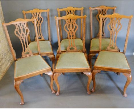 A Set of Six 19th Century Chippendale Style Dining Chairs, each with a pierced splat back above a padded seat raised upon cab