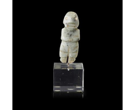 COSTA RICAN AXE IDOL  200 - 600 AD   pale green carving of an abstract form with incised details and hands to chest, mounted 
