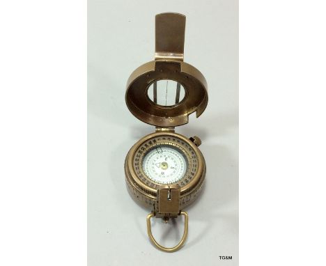 A brass military compass stamped TG & co London