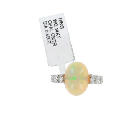 Beautiful Art Deco style ladies cocktail ring with an oval shape opal that is 4.52ct and 4pc diamonds on the sides weighting 